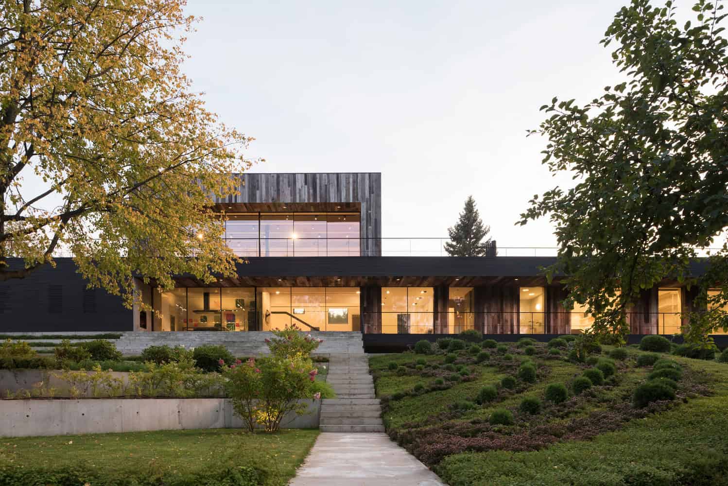 Contemporary modern house with sleek architectural design, large glass windows, and landscaped garden showcasing innovative architecture and stylish home exterior.