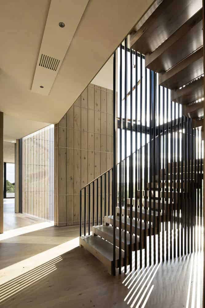 Kiht’han House Floating Stairs and Lightplay Floating staircase at Kiht’han House casting striking shadows through metal railing.