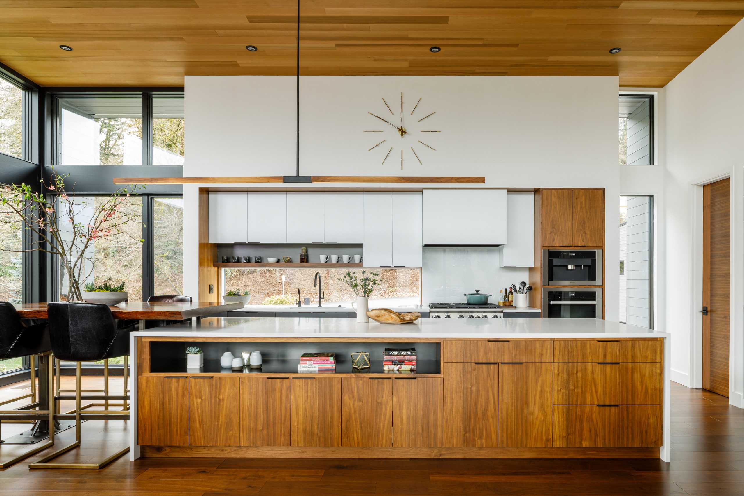 Mid-century modern kitchen with wooden cabinets, tiled backsplash, and pendant lighting