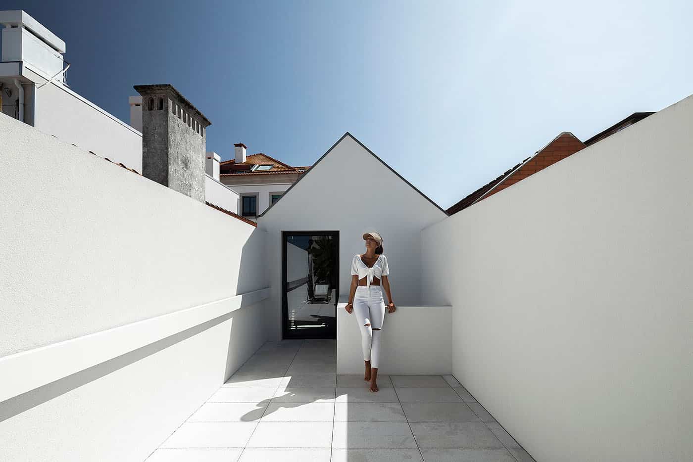 Modern minimalist rooftop terrace with white walls and sleek design, perfect for contemporary outdoor living. Classic architecture elements blend seamlessly with modern aesthetics.