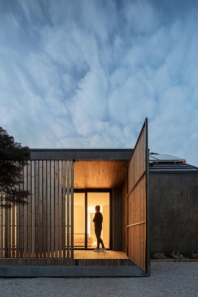 Opening the timber screens reveals a concrete House CG in Portugal