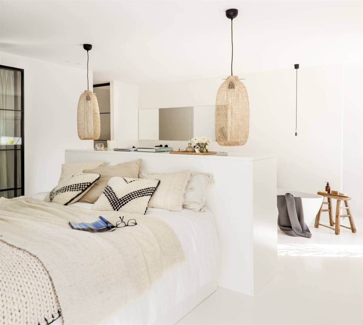 An En-Suite Bedroom with a Large White Bathroom An En-Suite Bedroom with a Large White Bathroom
