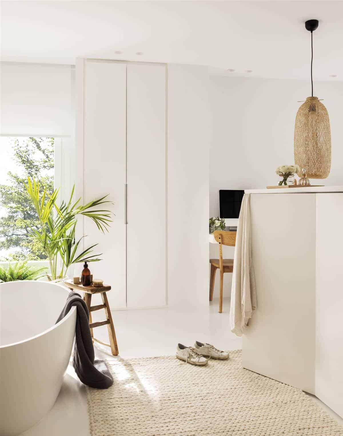 An En-Suite Bedroom with a Large White Bathroom An En-Suite Bedroom with a Large White Bathroom