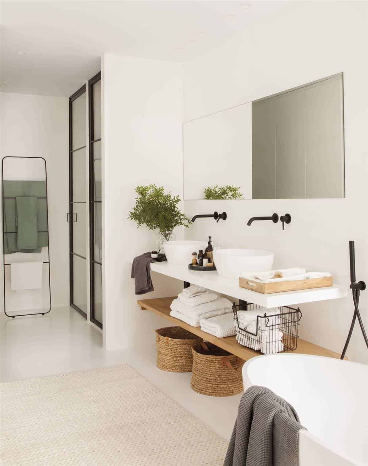 An En-Suite Bedroom with a Large White Bathroom An En-Suite Bedroom with a Large White Bathroom