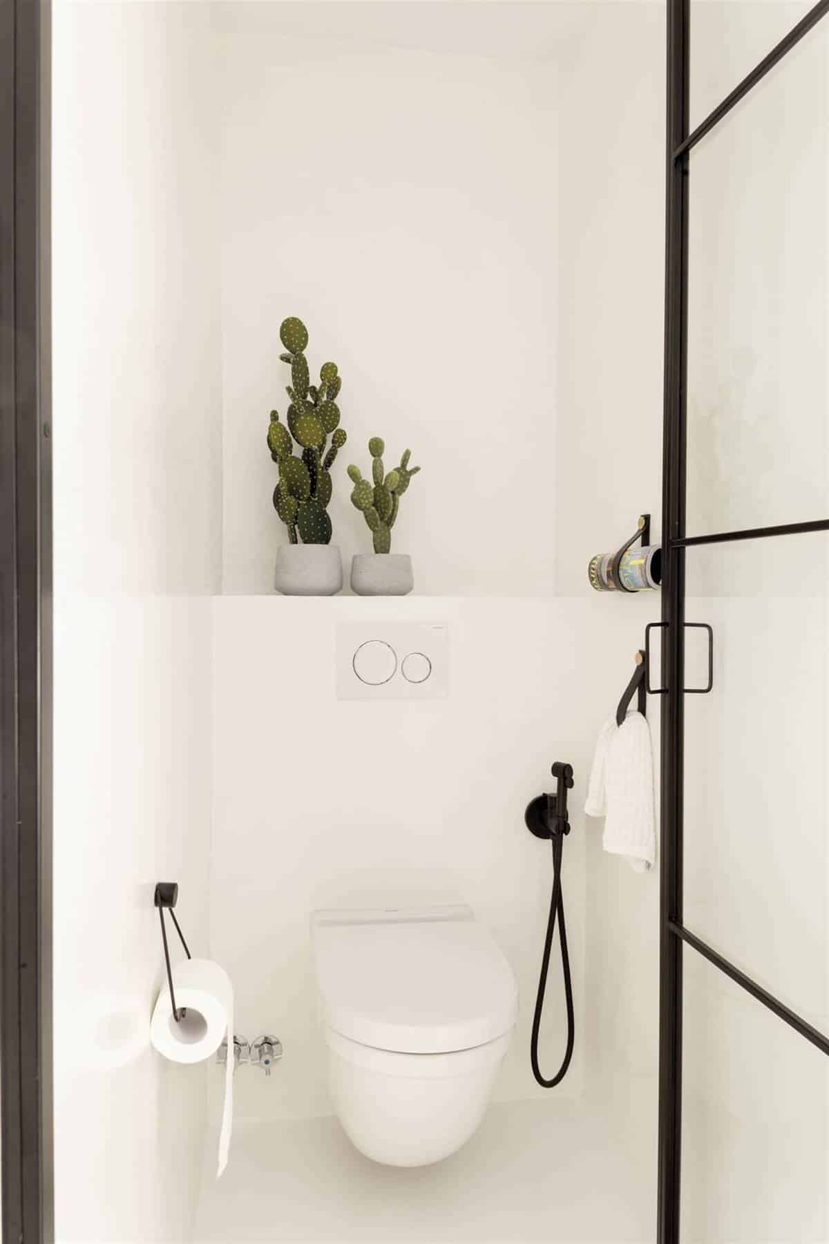 An En-Suite Bedroom with a Large White Bathroom An En-Suite Bedroom with a Large White Bathroom