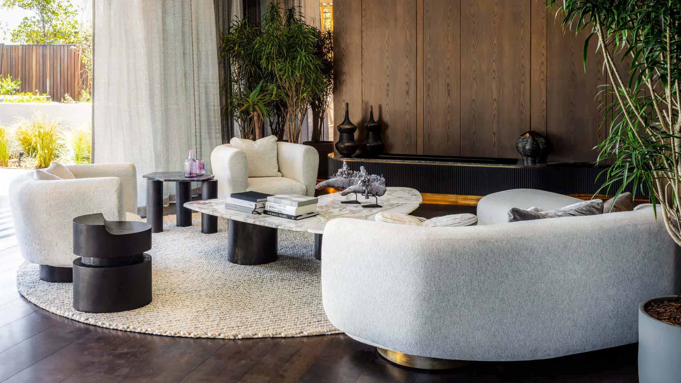 Elegant modern living room with contemporary furniture, natural lighting, and lush indoor plants, showcasing stylish interior design and architecture art.