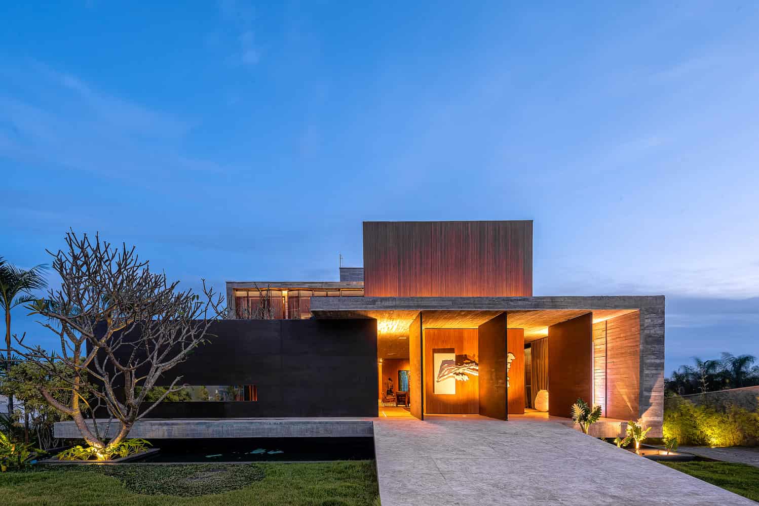 Contemporary architectural design house with modern materials and sleek lines, illuminated at dusk, showcasing innovative architecture art and design principles.