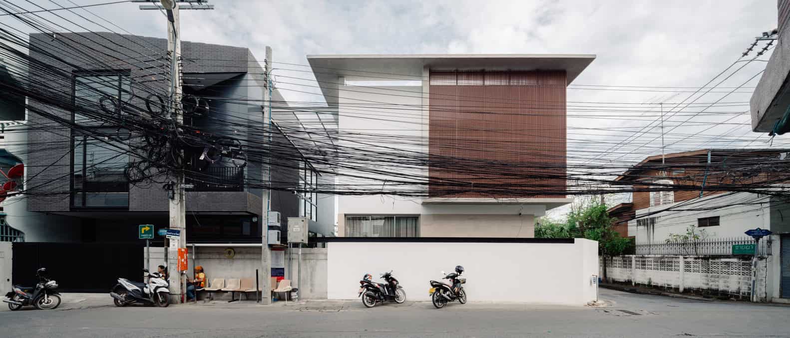 Modern minimalist house with contemporary architecture featuring clean lines and unique geometric design.