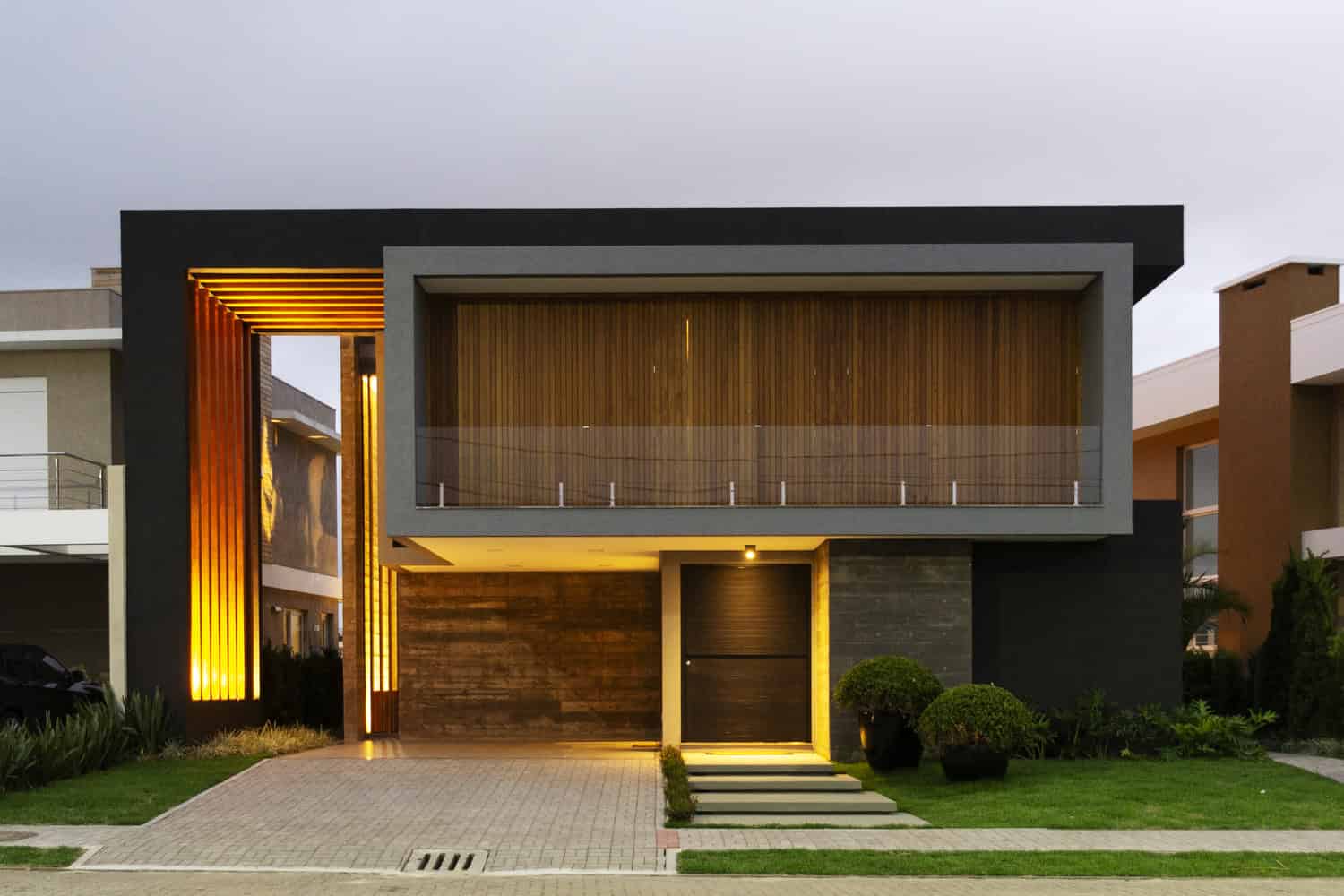 Contemporary modern house with geometric design, sleek black and gray exterior, wooden accents, and minimalist landscaping. Architectural art designs featuring innovative home architecture.