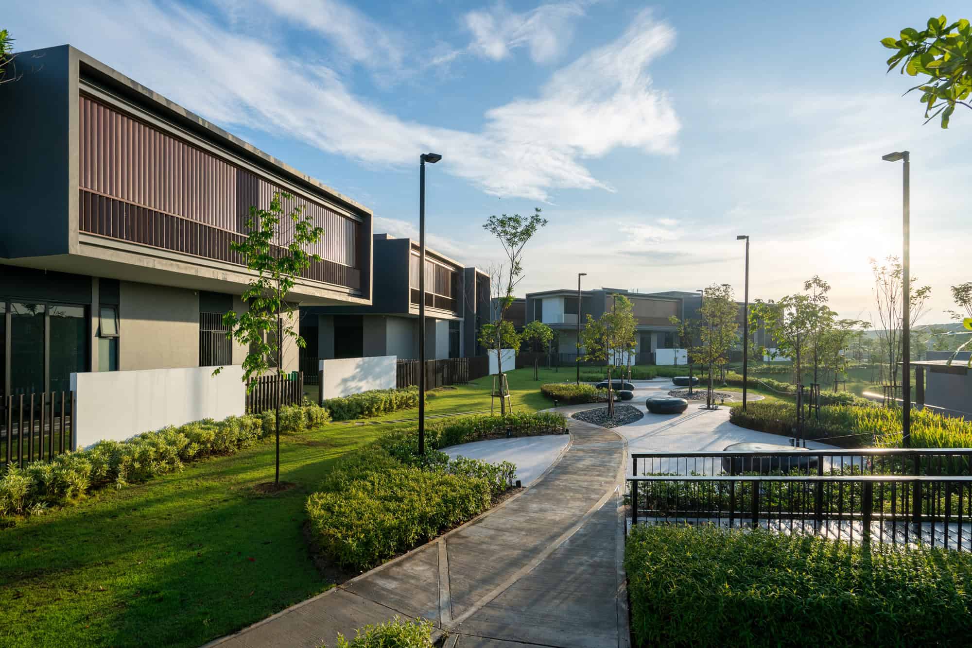 Modern residential complex featuring contemporary architectural design and lush landscaped gardens for sustainable urban living.