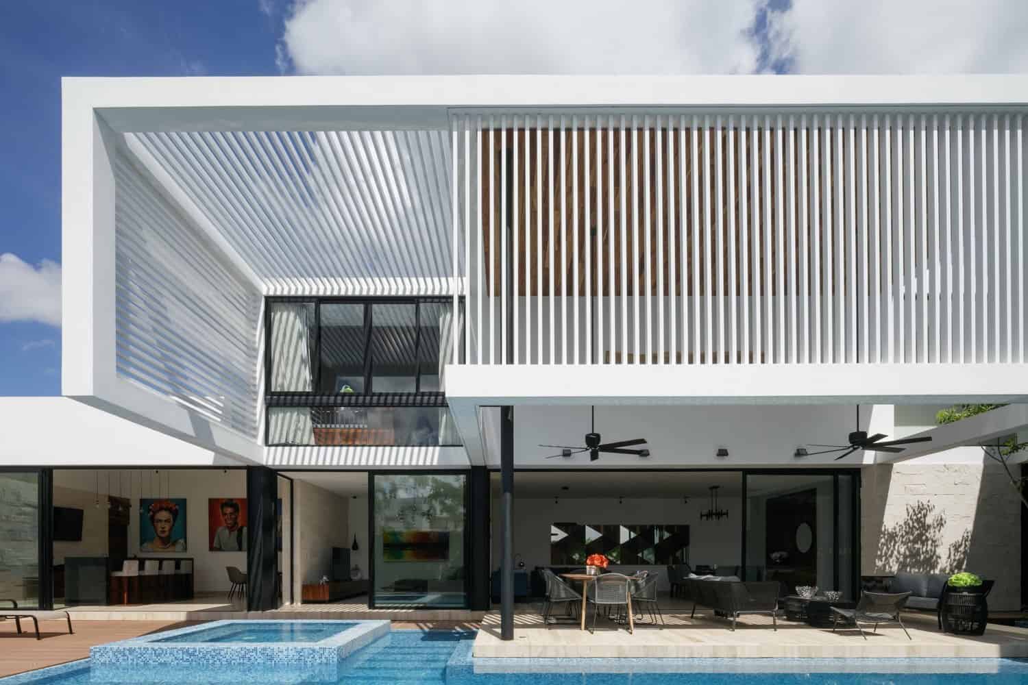Contemporary modern house with sleek white exterior, balconies with wooden slats, outdoor pool, and stylish patio area. Perfect design blending luxury and minimalism for smart architecture enthusiasts.