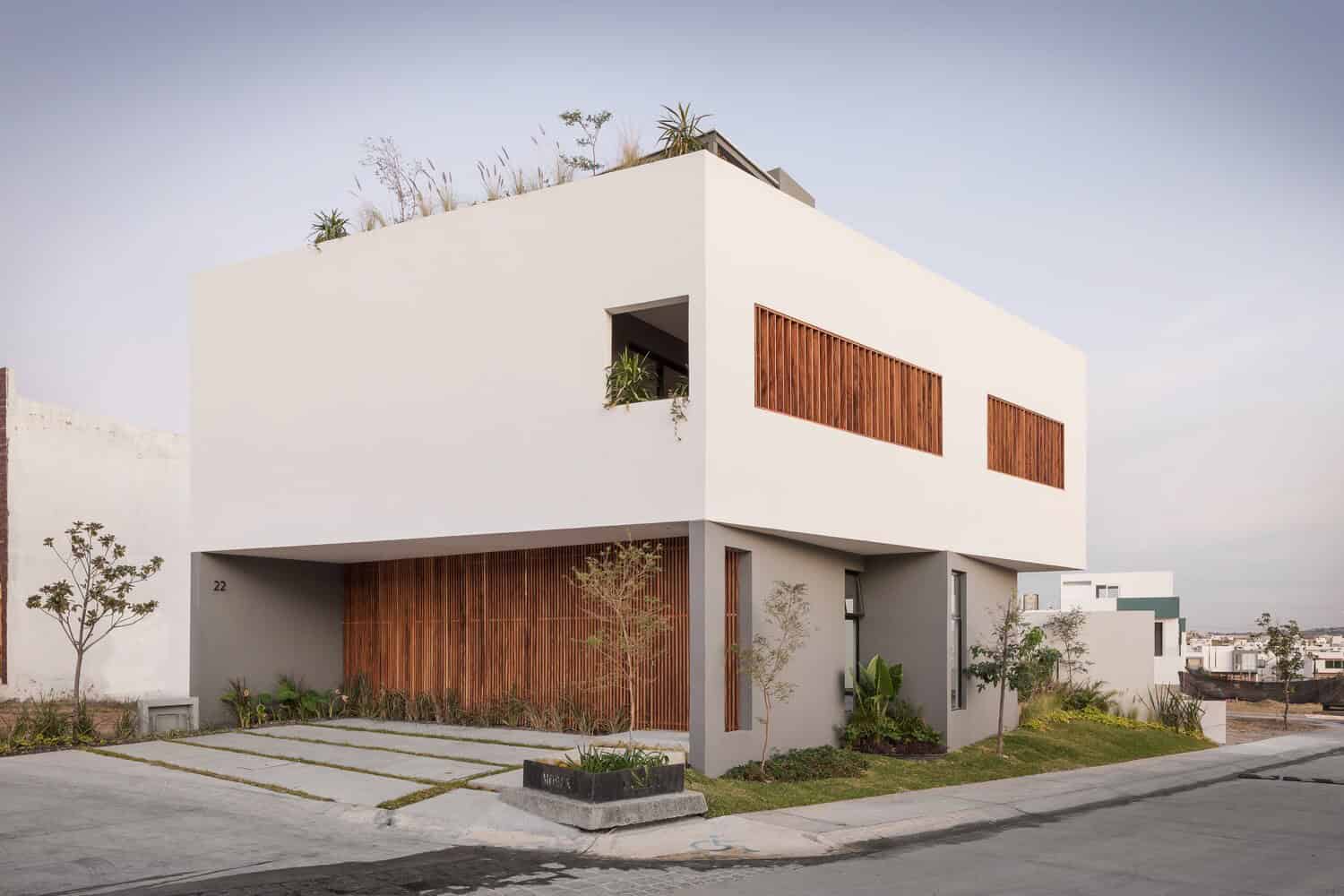 Contemporary modern house with minimalist design, clean white facade, wooden accents, and landscaped garden, ideal for innovative architecture and modern home design enthusiasts.