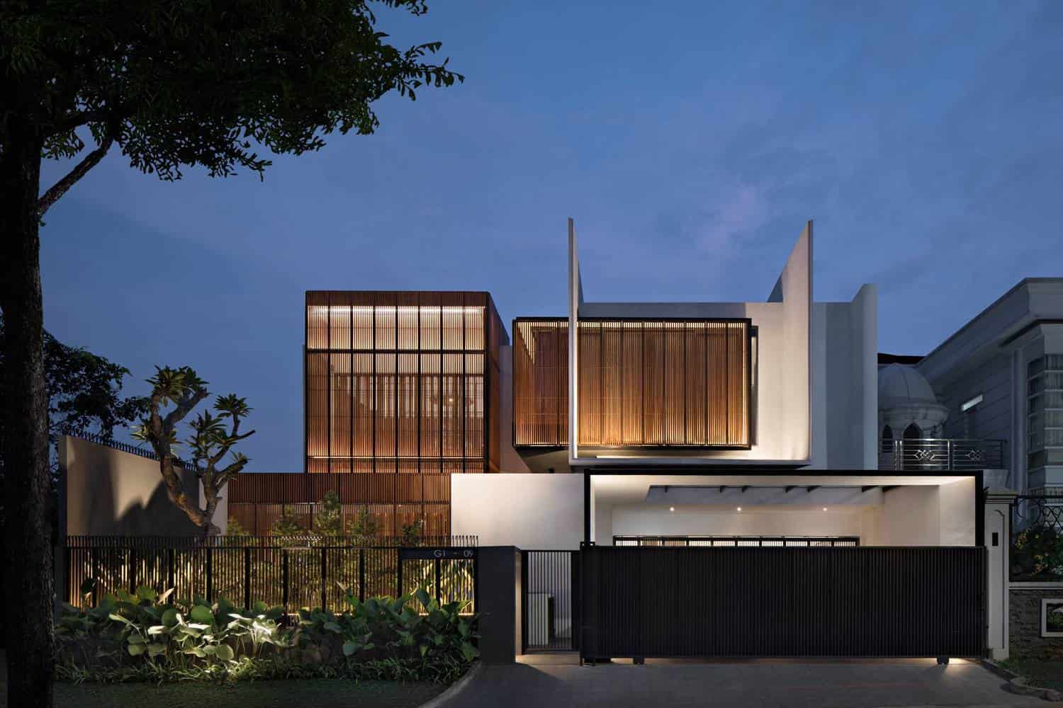 Sleek modern luxury house with wooden accents and contemporary architectural design at dusk.