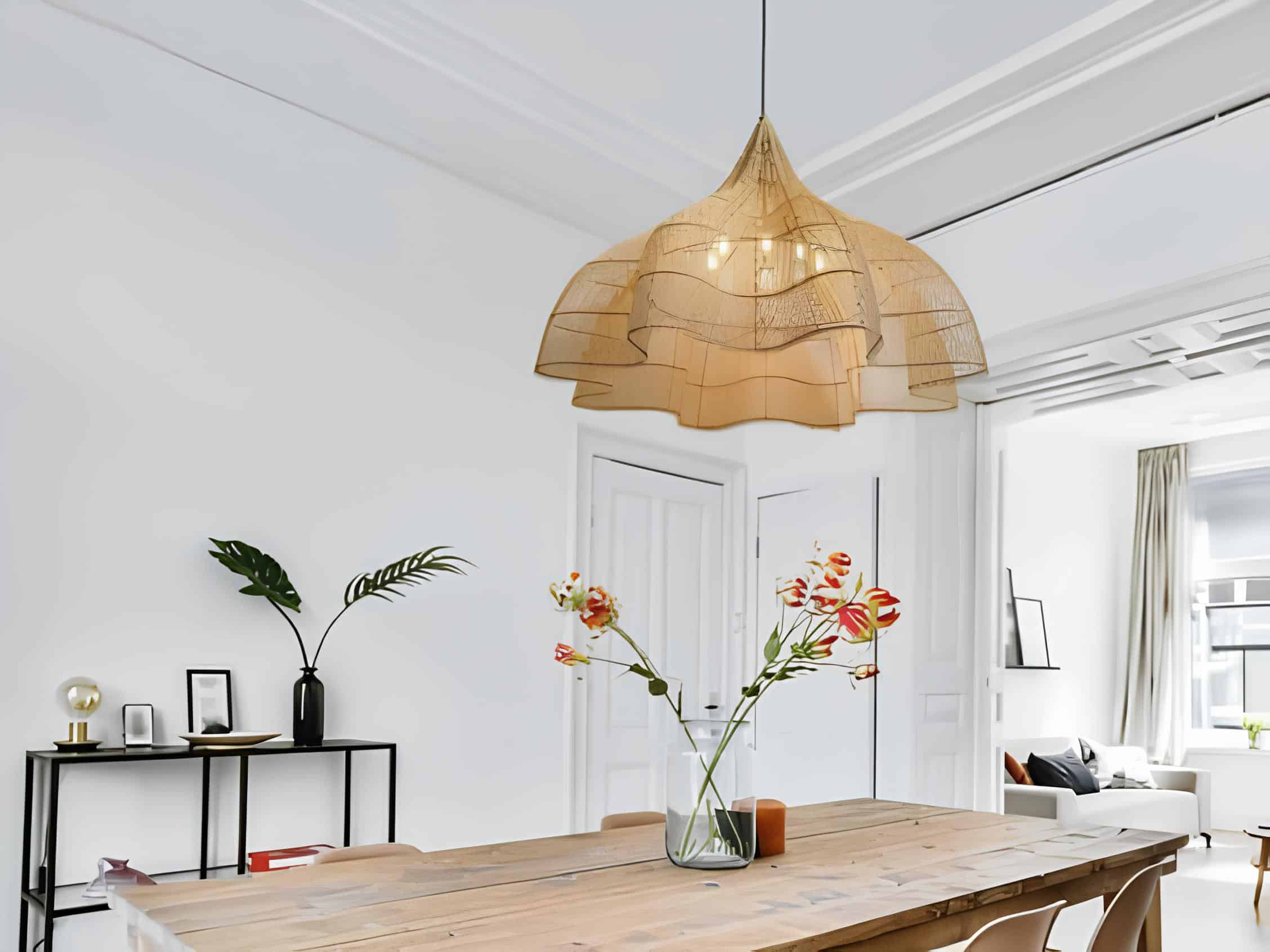 Modern dining table under flowing-shaped pendant lamp with tulip centerpiece