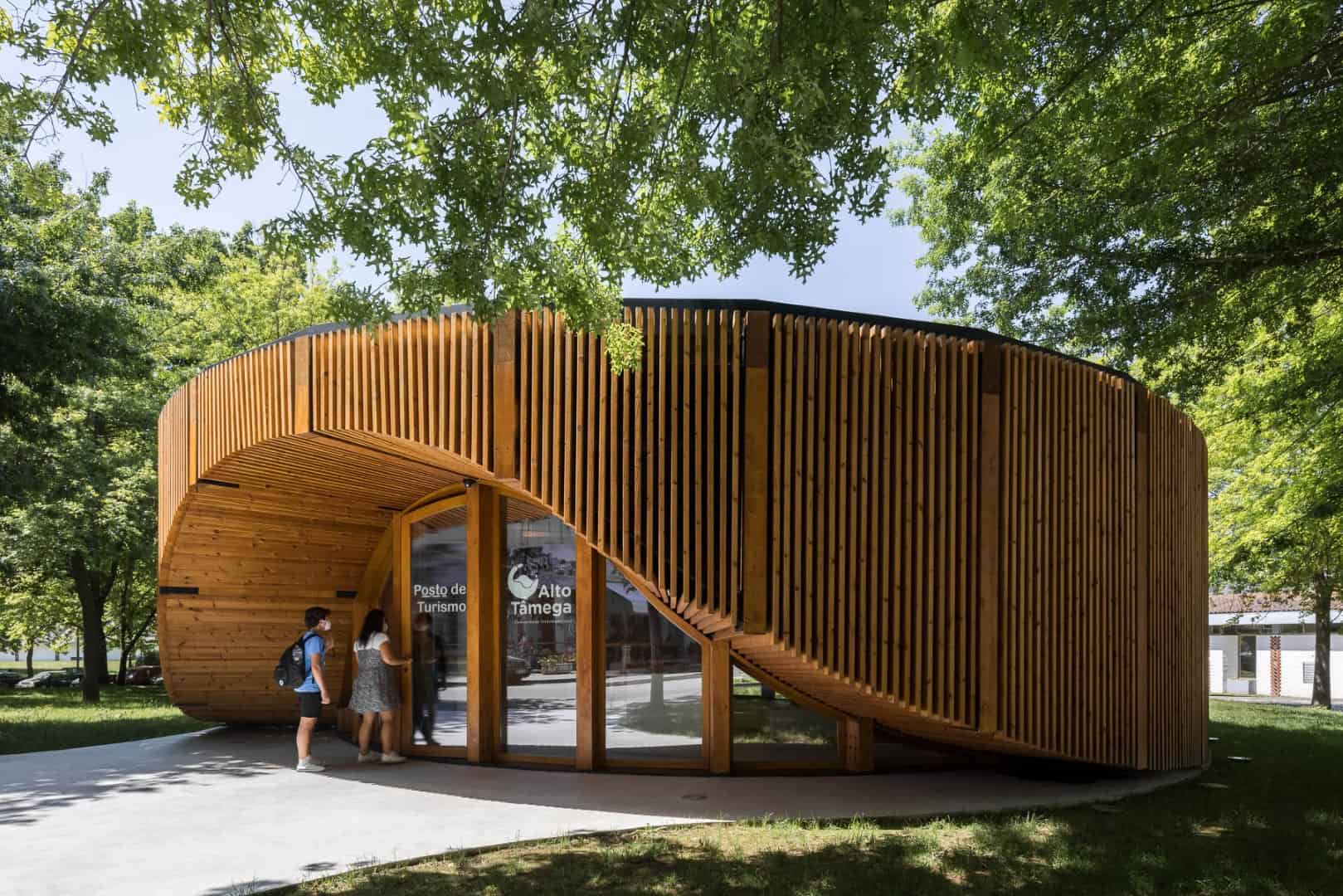 Wooden architecture pavilion with curved design, modern public space, and sustainable building materials.