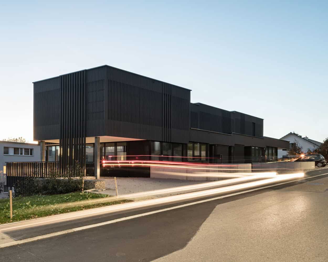 Futuristic modern black building with sleek design and vertical slats, showcasing contemporary architecture and innovative urban design.