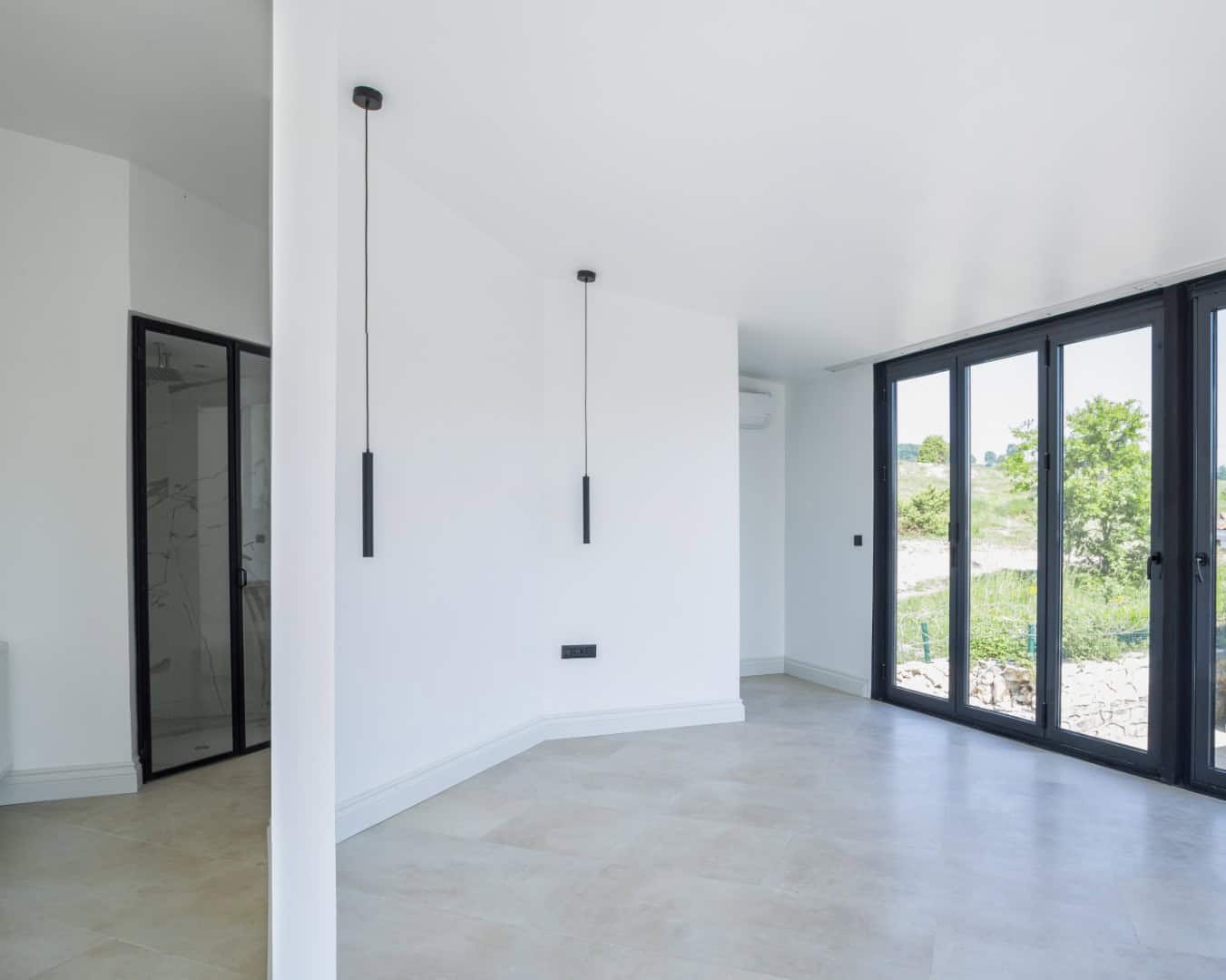 Modern wooden house with innovative curved architecture featuring contemporary design elements and outdoor seating area.