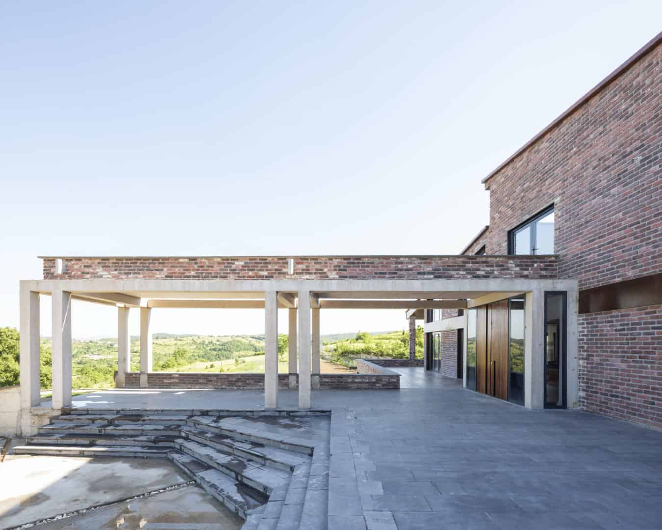 Bukhari House by Onur Karadeniz Architects in Istanbul, Turkey Modern wooden house with innovative curved architecture featuring contemporary design elements and outdoor seating area.