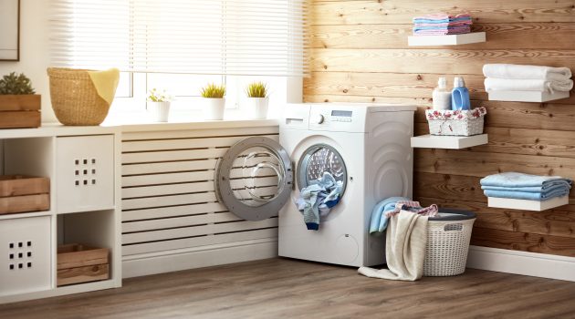 Interior of a real laundry room with a washing machine at the window at home