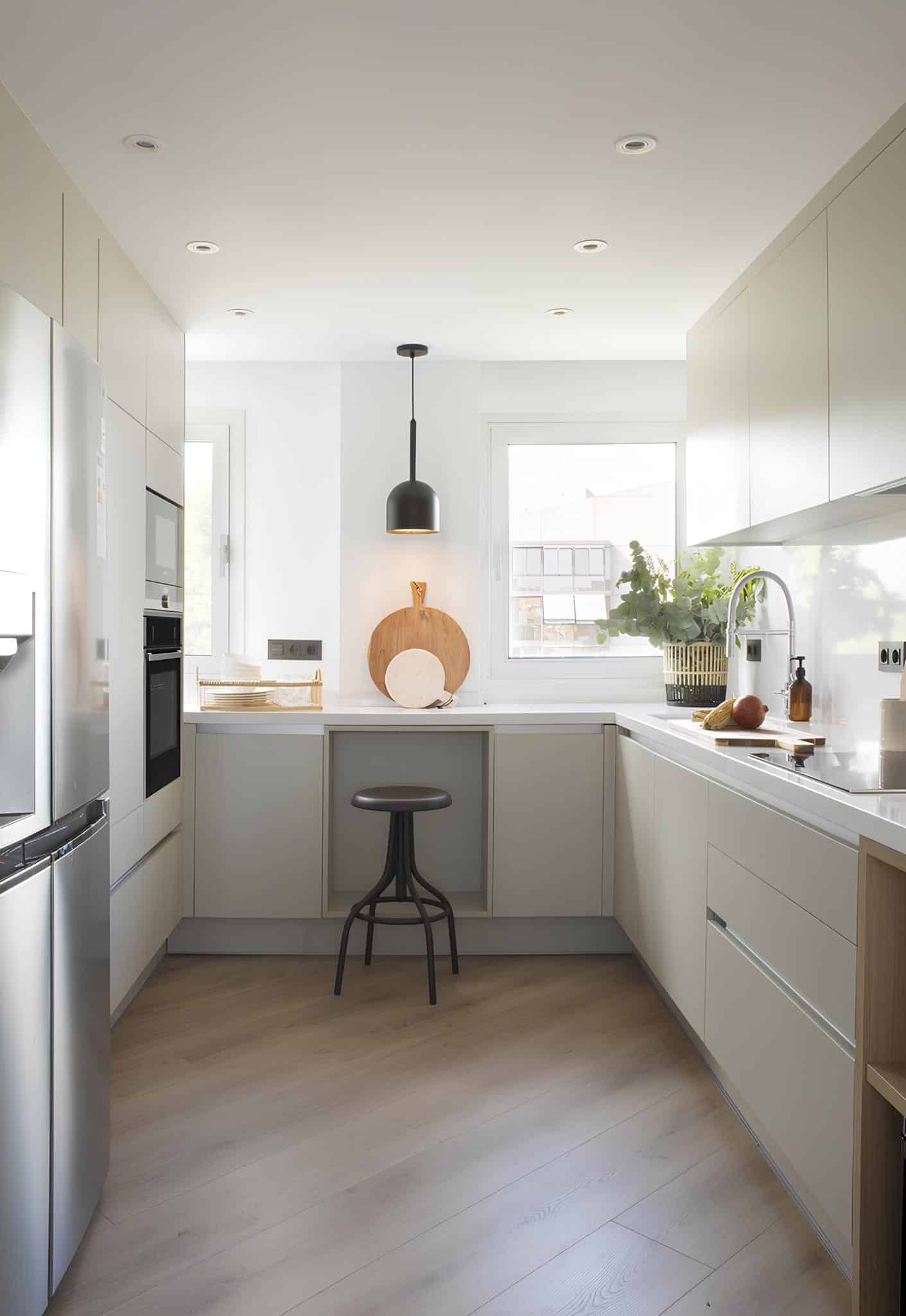 Bright minimalist kitchen with island seating and large windows