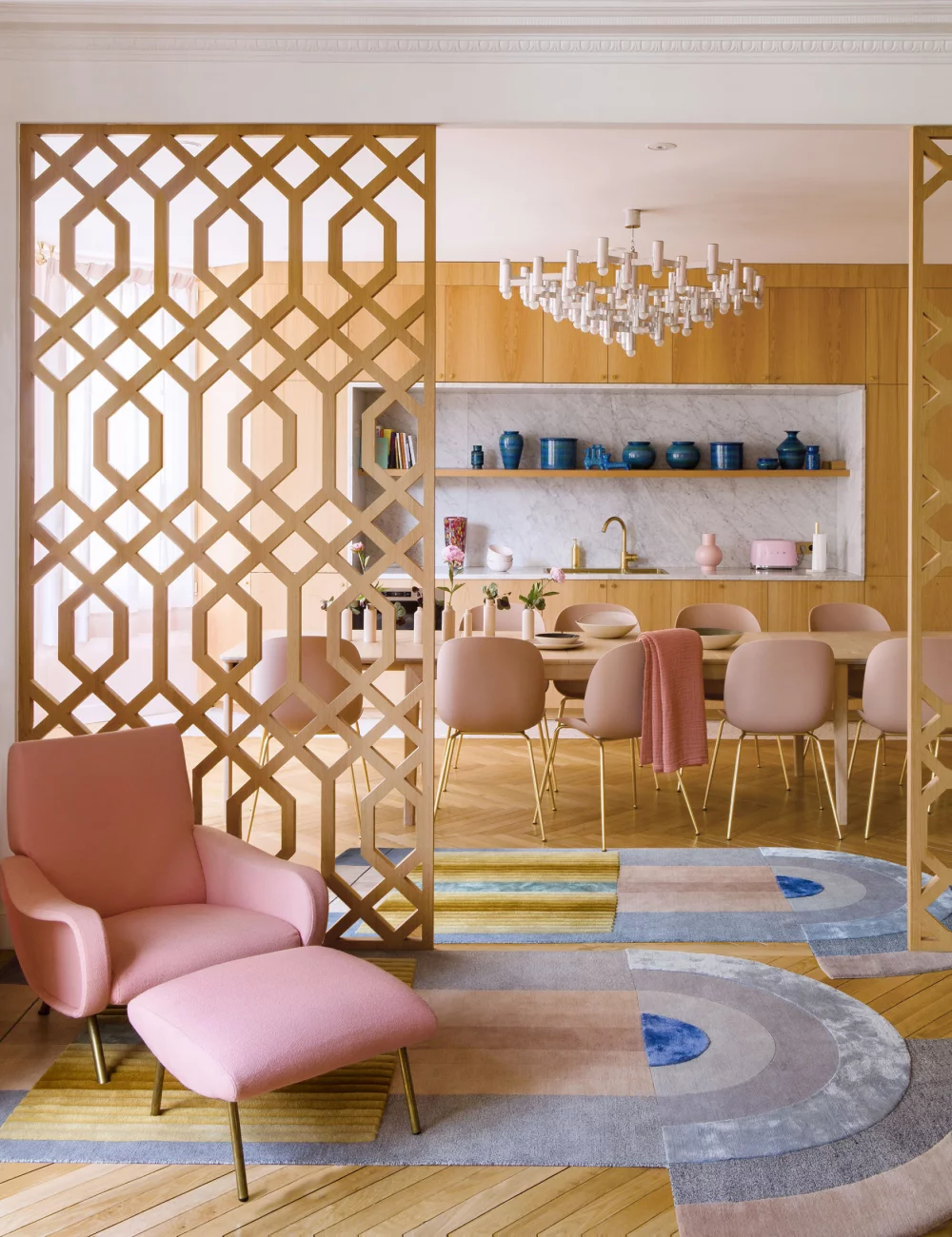 A kitchen open to a living room with screens A kitchen open to a living room with screens