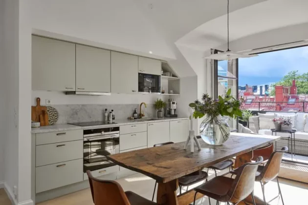 Spacious and bright Swedish penthouse with large windows opening onto the terrace