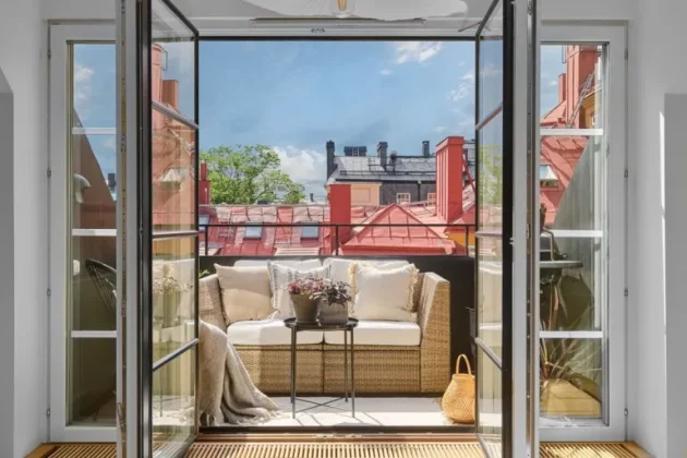 Spacious and bright Swedish penthouse with large windows opening onto the terrace
