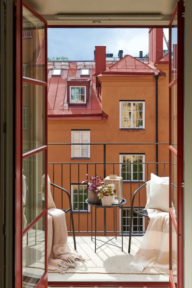 Spacious and bright Swedish penthouse with large windows opening onto the terrace
