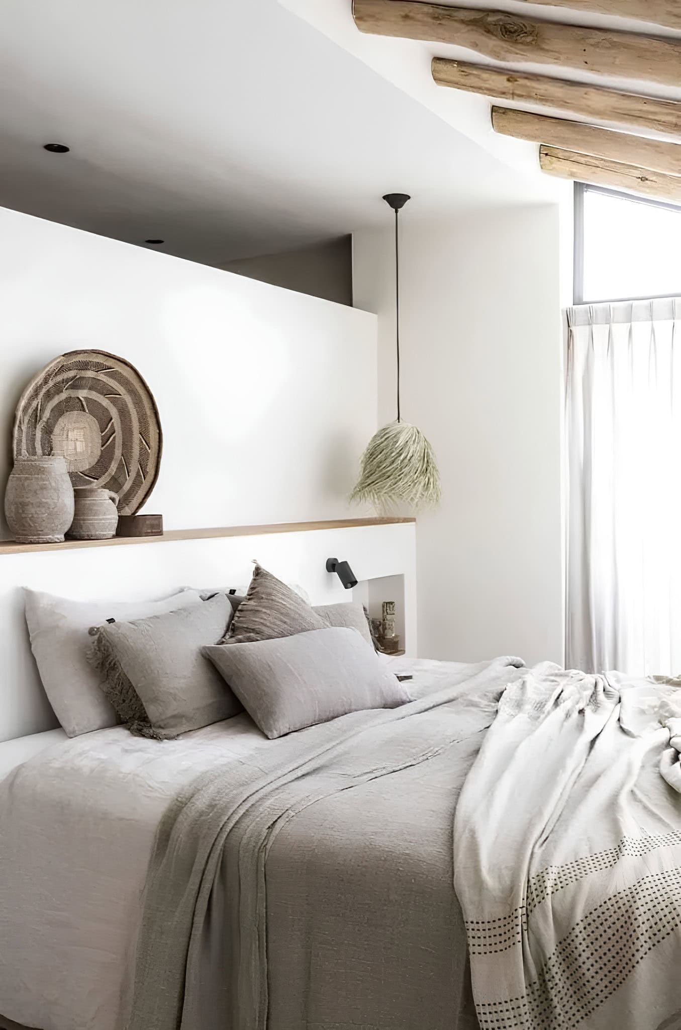 Mediterranean Style Bedroom Textured Bedding Soft-toned bedroom with wood ceiling beams and artisanal woven decor.