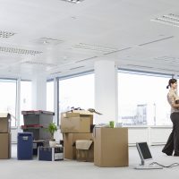 19522699 - businesswoman in office with moving supplies
