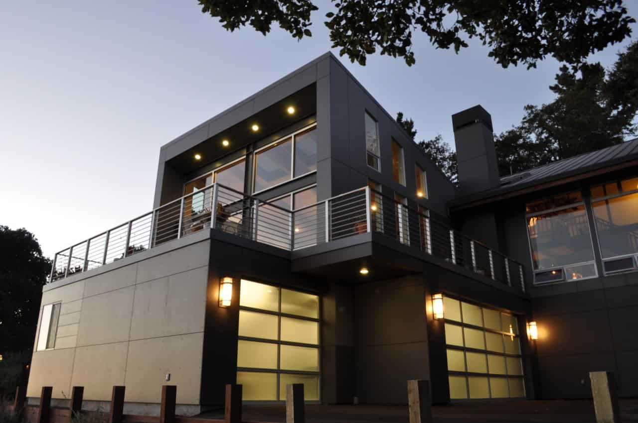 Contemporary modern house with sleek design, large glass windows, and spacious balcony, featuring minimalist architecture and stylish exterior lighting for luxury home appeal.