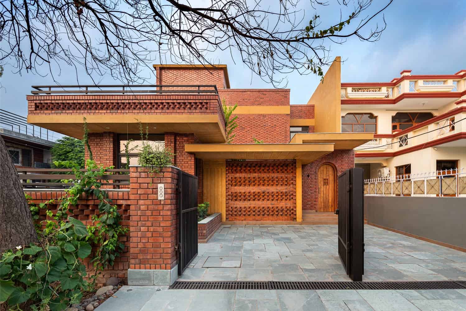 Modern brick house architecture with a stylish entrance and contemporary design elements.