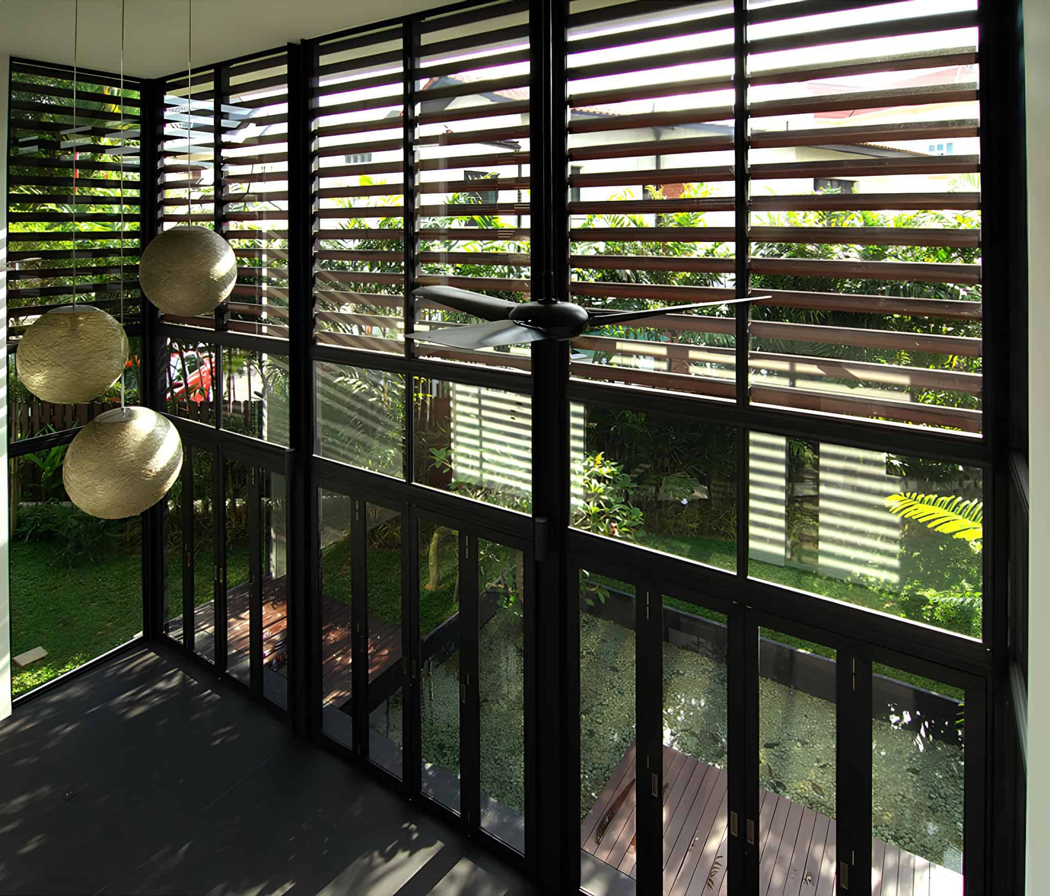 Jalan Merlimau Interior Louvered Windows Interior view through large louvered windows at Jalan Merlimau with hanging lights.