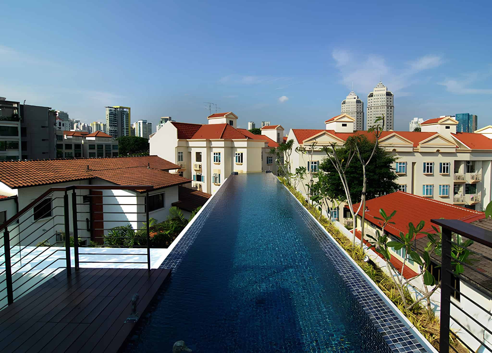 Jalan Merlimau Rooftop Lap Pool Stunning rooftop lap pool with views of the surrounding red-roofed villas in Singapore.
