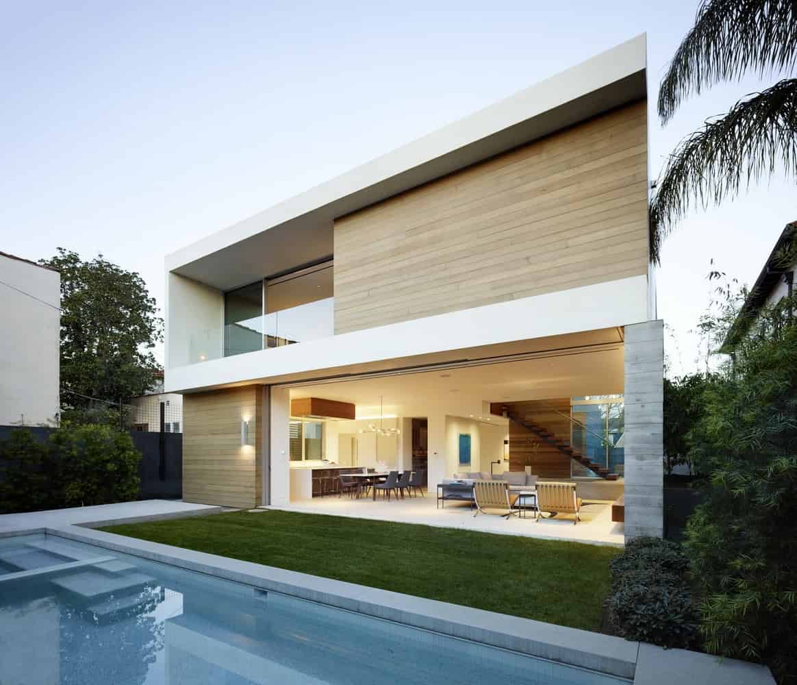 Modern minimalist house featuring clean lines, large glass windows, wooden accents, and an outdoor patio with pool, exemplifying contemporary architecture and innovative design.