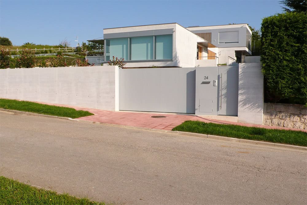 Modern minimalist house with clean lines and large windows, showcasing contemporary architecture and innovative design elements.