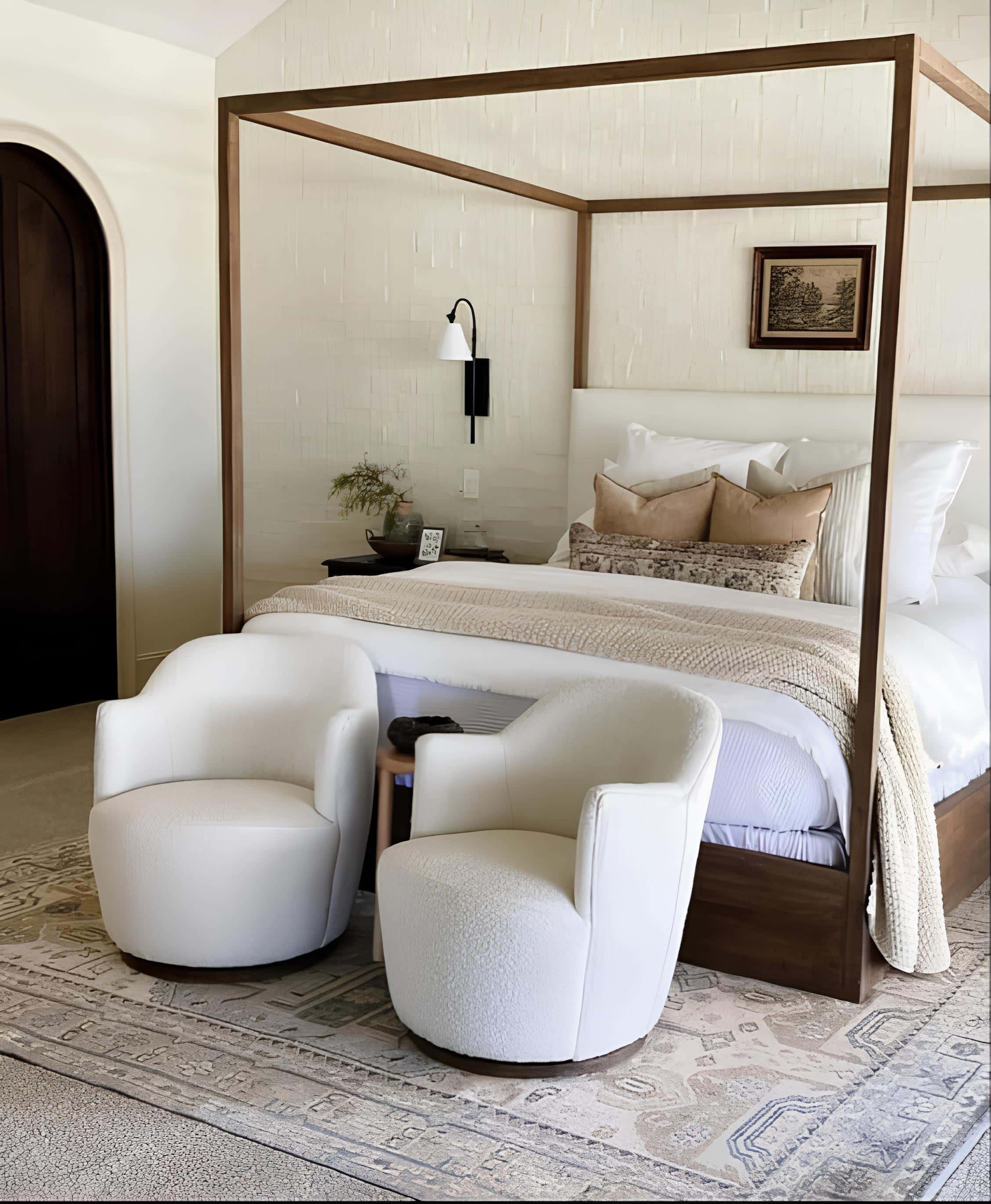 Modern Bedroom with Canopy Bed and White Chairs Stylish bedroom with a canopy bed, plush white chairs, and textured accent wall.