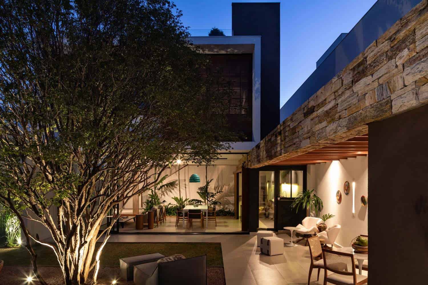 Modern outdoor architectural design with contemporary patios and hanging lighting, featuring sleek furniture and lush greenery for stylish home aesthetics.