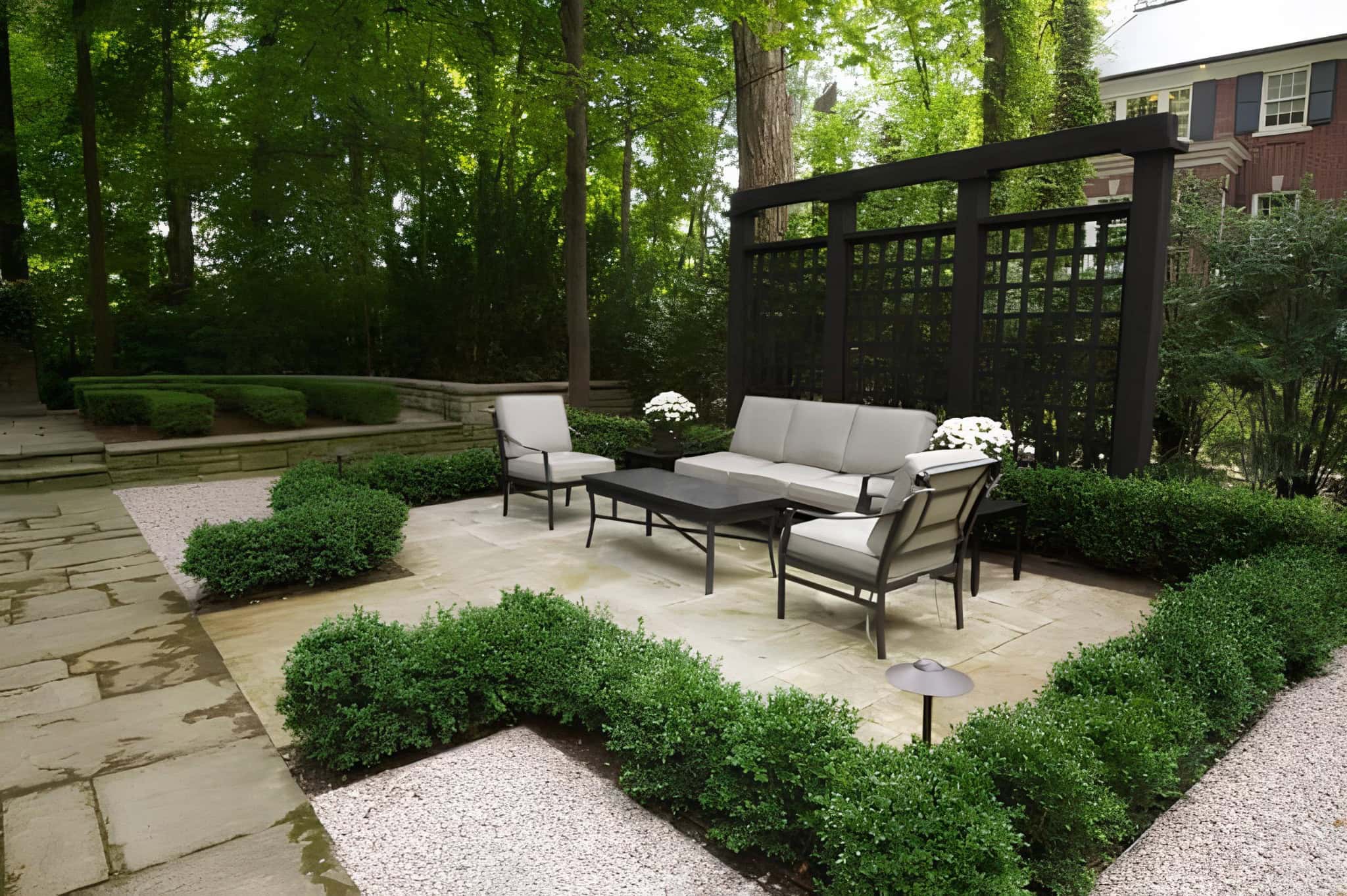 Elegant garden patio with black lattice screen and formal seating