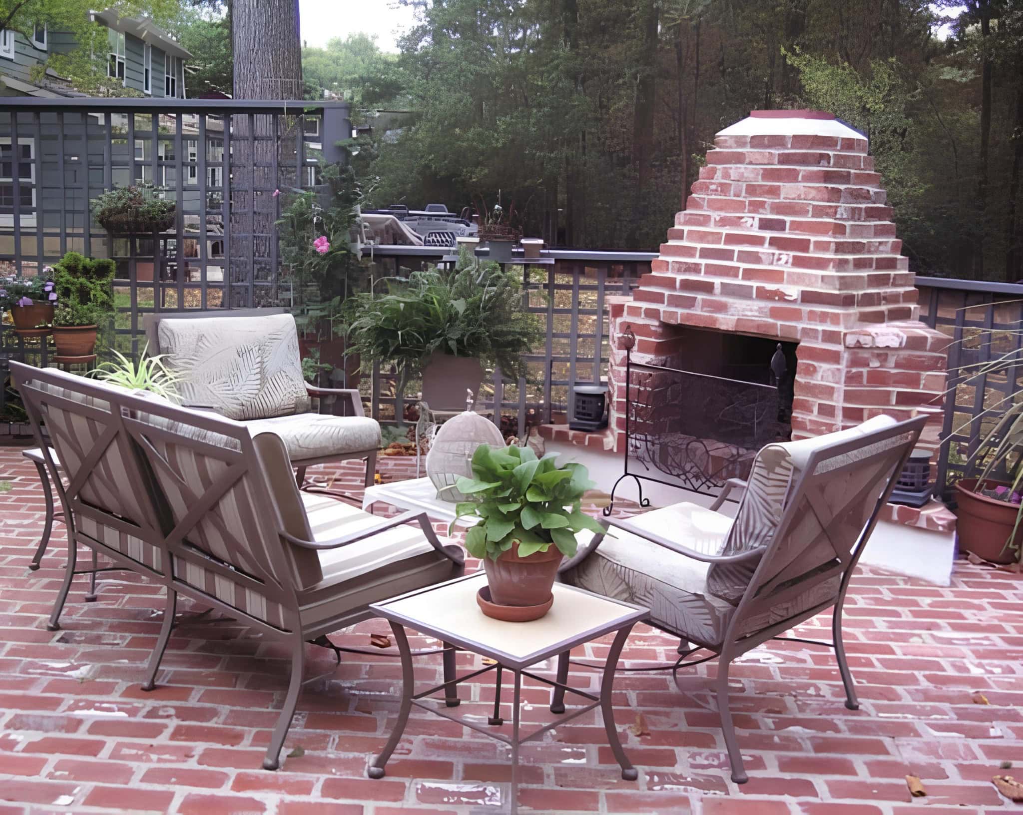 Outdoor patio with brick fireplace and metal lattice privacy fence