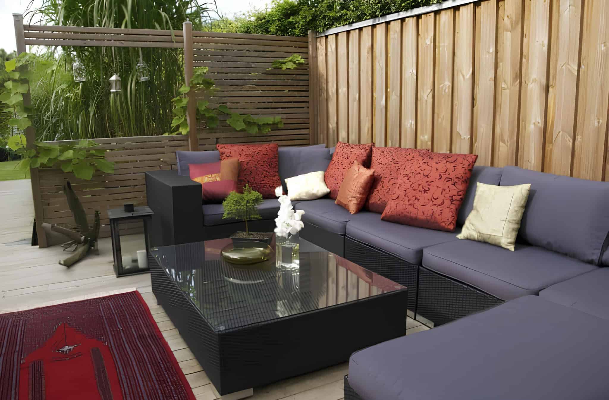 Outdoor wooden privacy screen on a cozy patio with seating and throw pillows
