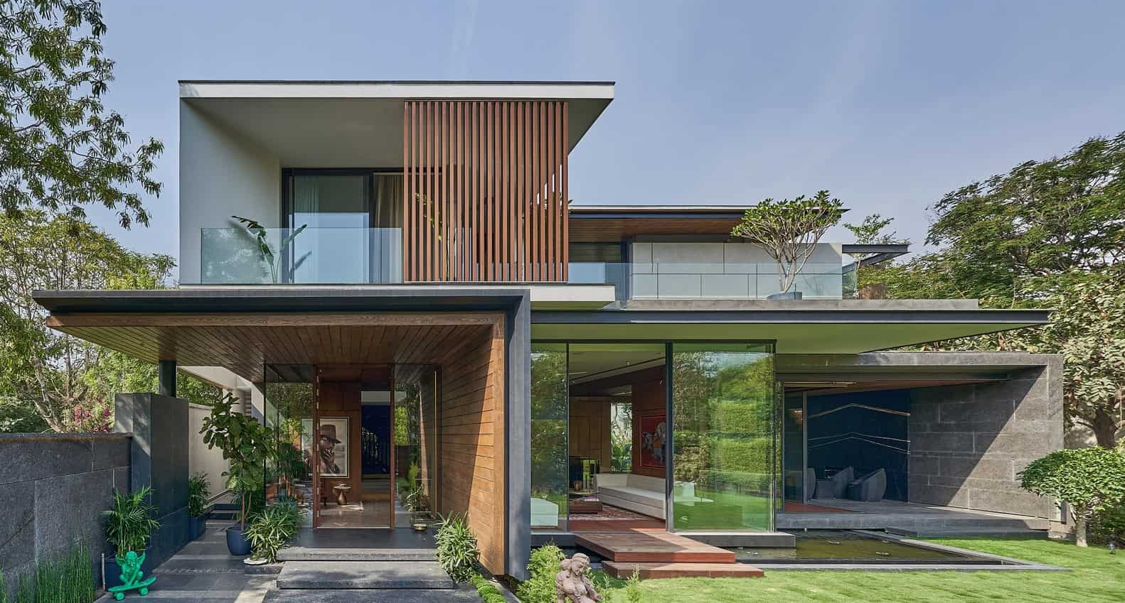 Modern house with green lawn and trees