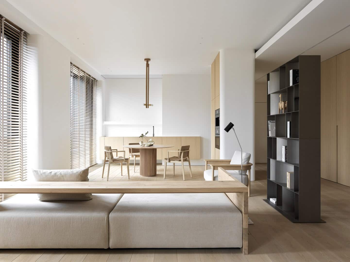 Modern minimalist living and dining room interior with neutral color palette, wooden accents, and ample natural light, showcasing contemporary home design and interior architecture.