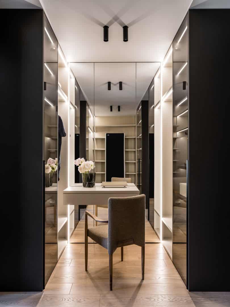 1,800 sf Apartment / Alexander Tischler / Russia Green armchair and Kartell coffee table adding color to bedroom