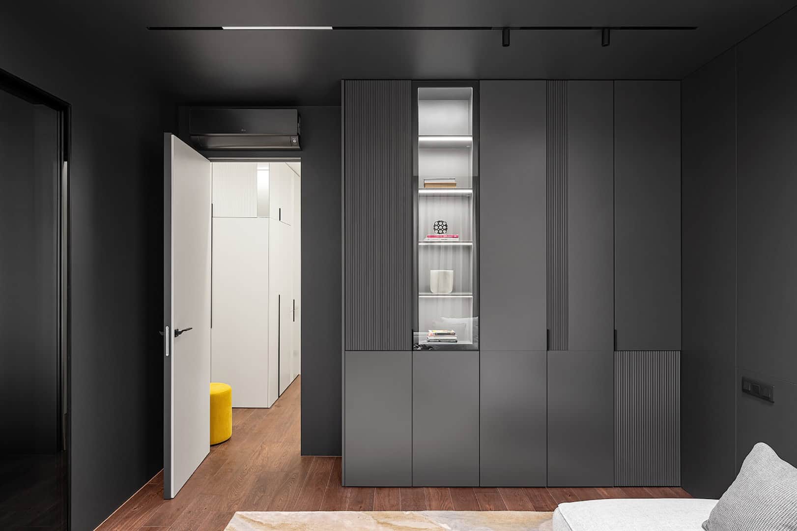 Apartment for a Software Developer / Alexander Tischler / Russia Graphic cabinet anchoring the darker living corner
