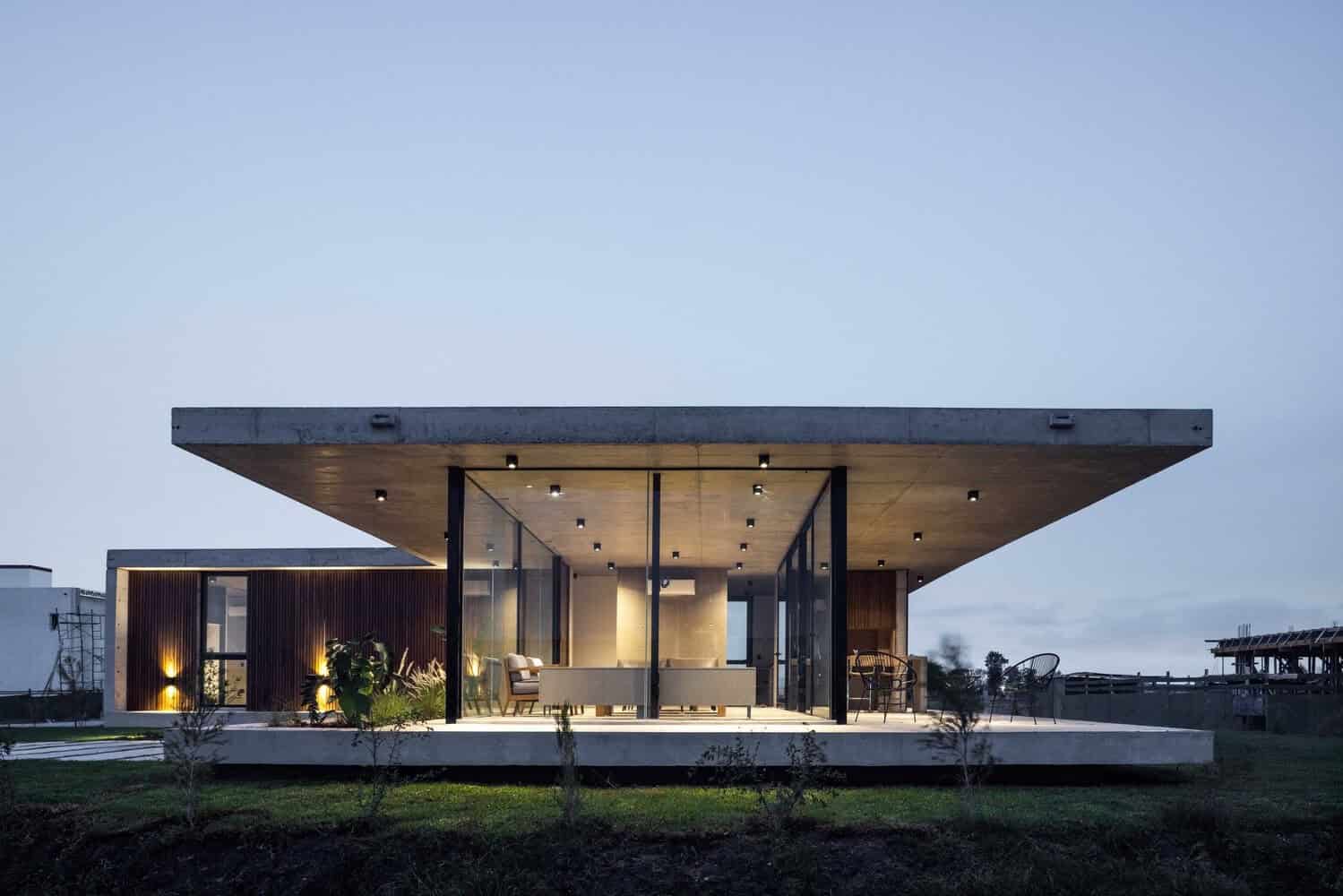 Sleek modern minimalist concrete and glass house with spacious outdoor terrace, contemporary architecture design, ideal for modern home living.