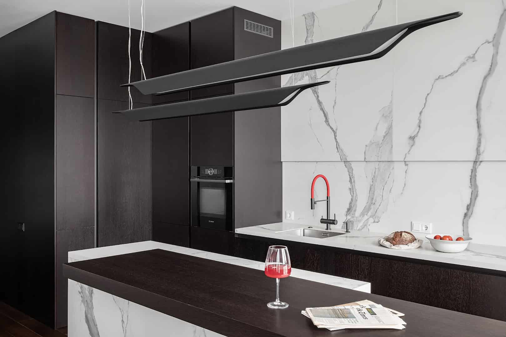 Three-Bedroom Apartment / Alexander Tischler / Russia Great room centered by a marble island and layered lighting