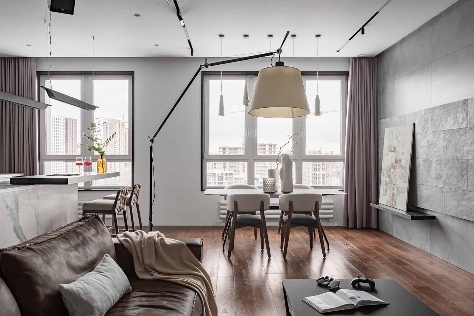 Modern minimalist apartment interior with large windows, stylish furniture, and contemporary lighting, showcasing trendy home decor and natural light for urban living.