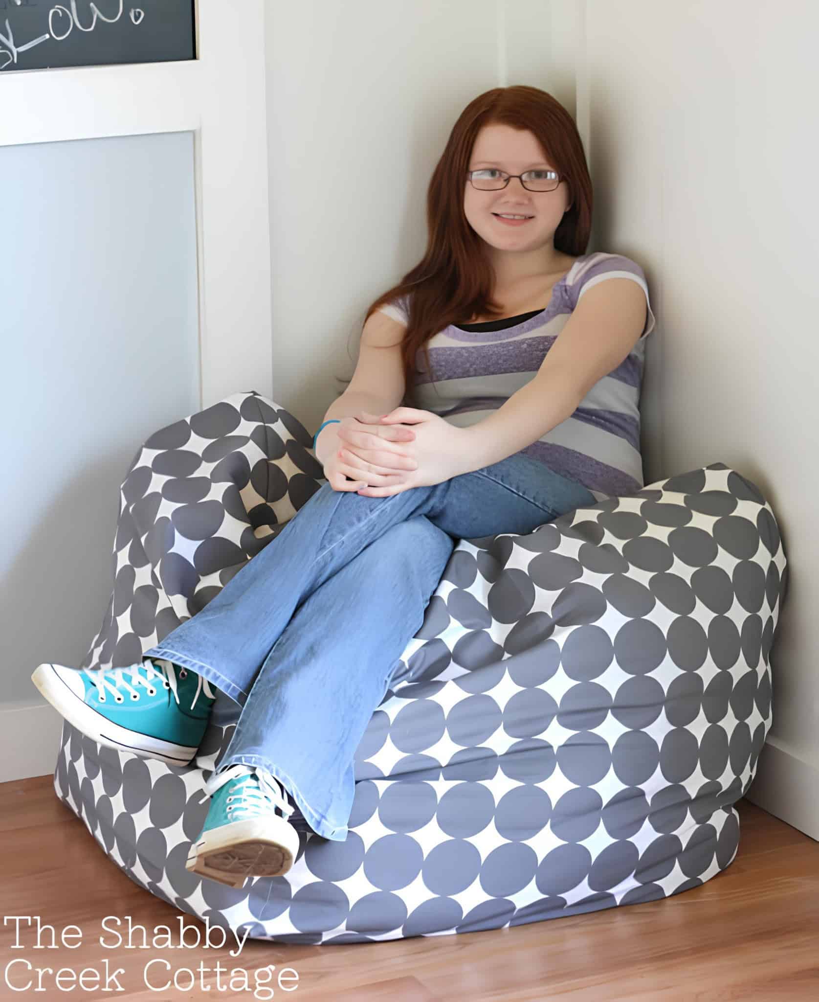Grey Polka Dot Beanbag Corner Seat Teen girl lounging in grey beanbag with large white dots
