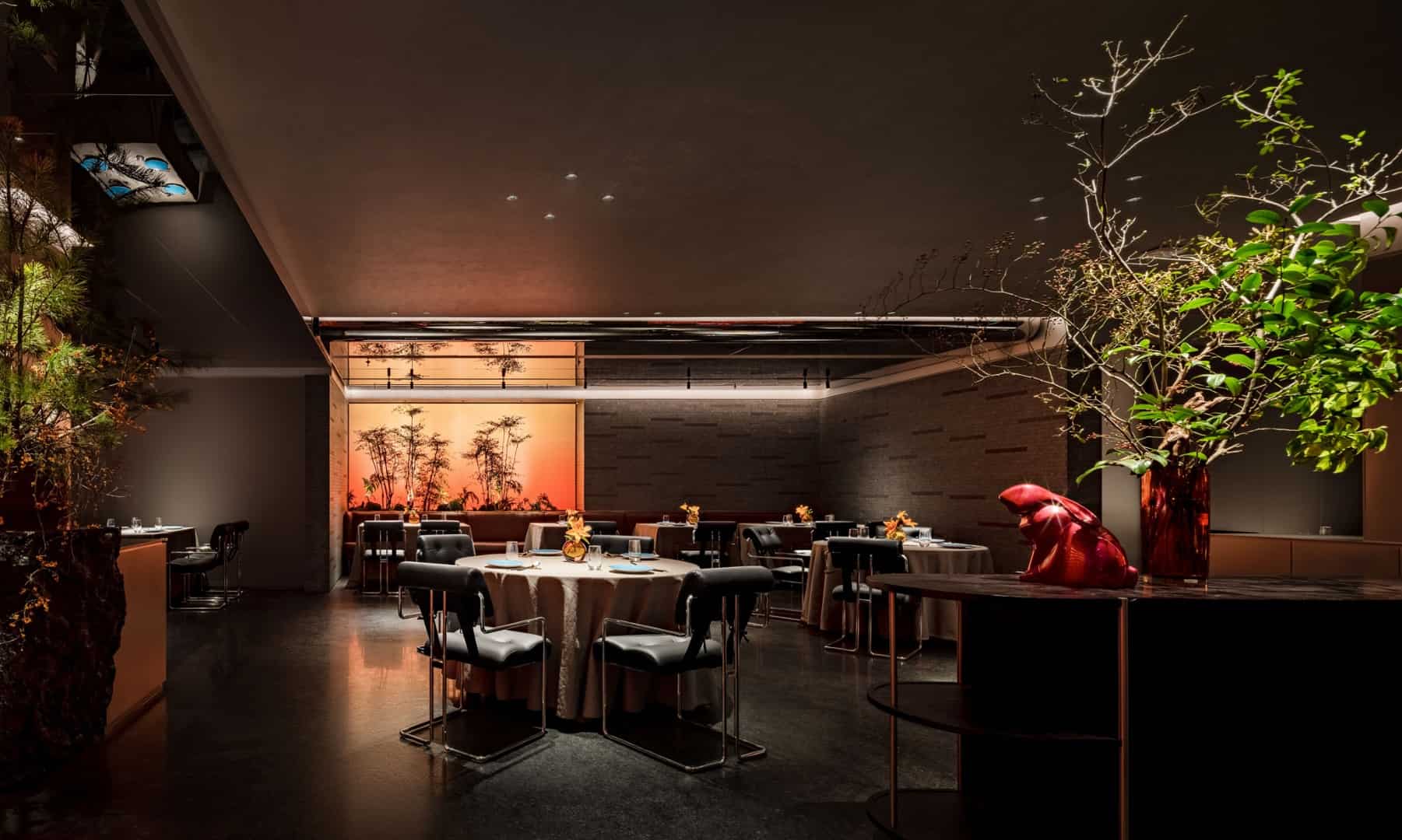 Elegant modern restaurant interior with contemporary decor, lush plant accents, and warm ambient lighting, showcasing innovative architecture and stylish interior design elements.